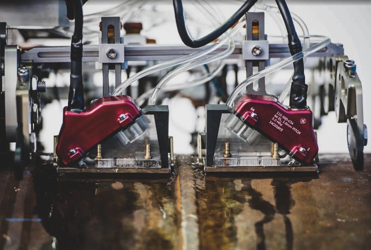 Phased-array ultrasonic probe wedges mounted on an automated ultrasonic scanning frame